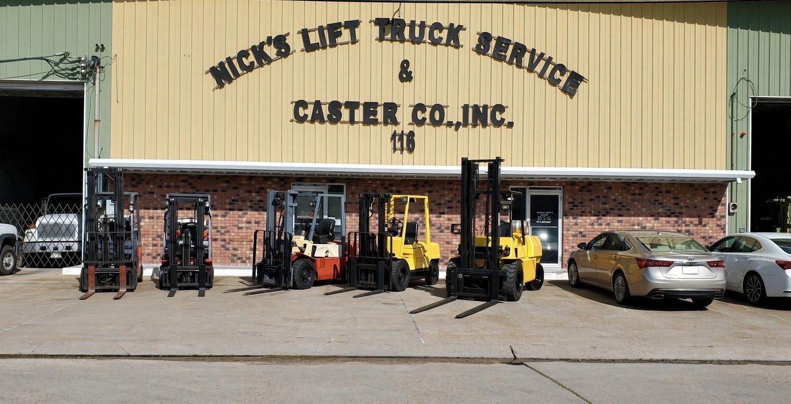 Nick's Lift Truck Service shop at 116, with forklifts parked in front of the building